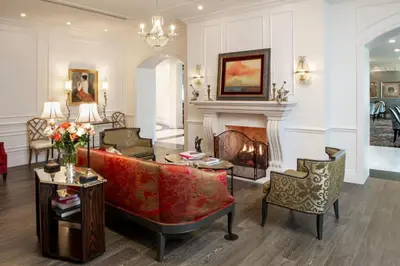 a living room with a couch and a fireplace at Mirbeau Inn & Spa, Rhinebeck in Rhinebeck