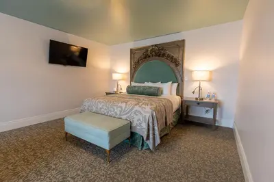 a bedroom with a bed with a large mirror at Mirbeau Inn & Spa, Rhinebeck in Rhinebeck