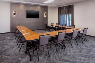 a conference room with a large table and chairs at Hyatt Place Poughkeepsie - Hudson Valley in Poughkeepsie