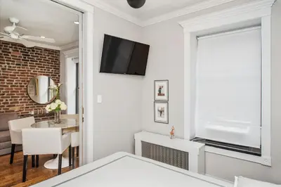 a living room with a tv on the wall at APARTMENT NOLITA in New York