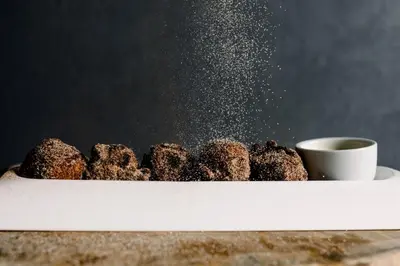 a plate of chocolate donuts and a cup of coffee at The Study at Yale, Study Hotels in New Haven