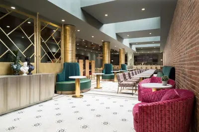 a lobby with a row of chairs and tables at TRYP by Wyndham Newark Downtown in Newark