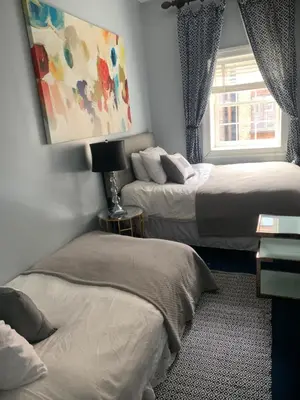 a bedroom with two beds and a window at TOWNHOUSE 222 in New York