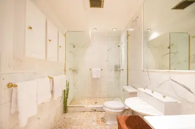 a white bathroom with a toilet and a sink at TOWNHOUSE 222 in New York