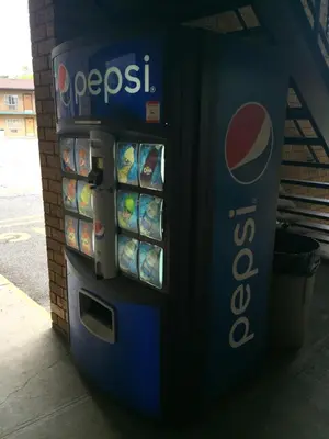 a pepsi vending machine with food and drinks at Hudson Plaza Motel Bayonne Jersey City in Jersey City