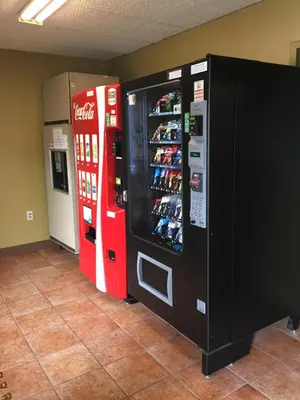 a coca cola machine and a soda machine at Hudson Plaza Motel Bayonne Jersey City in Jersey City