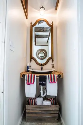 a bathroom with a sink and a mirror at The Connecticut River Valley Inn Hartford South/Glastonbury in Glastonbury
