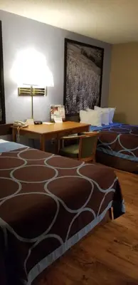 a hotel room with two beds and a desk at Super 8 by Wyndham East Stroudsburg - Poconos in East Stroudsburg