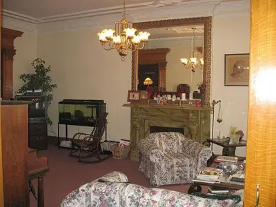 a living room with a fireplace and a tv at Olde Judge Mansion B&B in Troy