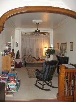 a living room with a chair and a couch at Olde Judge Mansion B&B in Troy