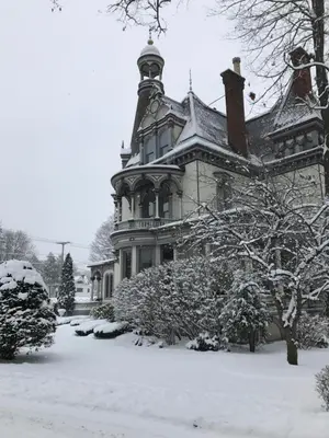 a large house with snow on the ground at Batcheller Mansion Inn in Saratoga Springs