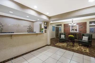 a lobby with two chairs and a waiting room at Howard Johnson by Wyndham Springfield in Springfield
