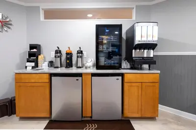 a kitchen with a counter with a drink dispenser at Red Roof Inn and Suites Herkimer in Herkimer
