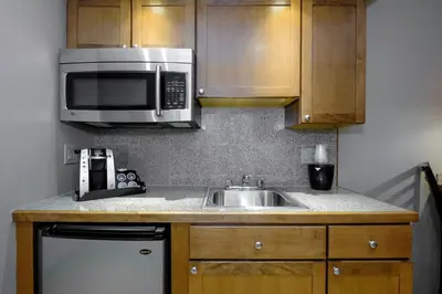 a kitchen with a sink and a microwave at Red Roof Inn and Suites Herkimer in Herkimer
