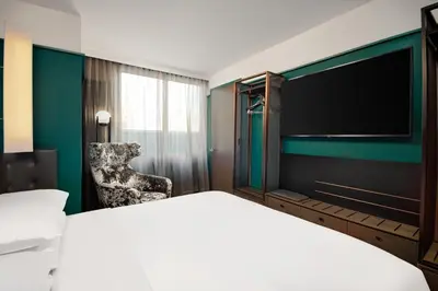 a hotel room with a large bed and a chair at Hyatt Centric Midtown 5th Avenue New York in New York