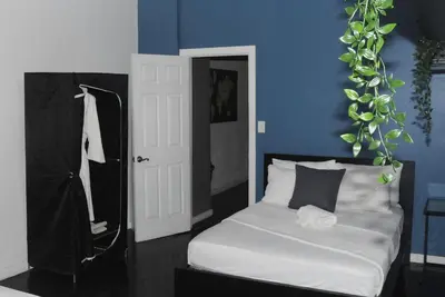 a bedroom with a white bed and a blue wall at Plush Spacious 1 bedroom apt Williamsburg in Brooklyn