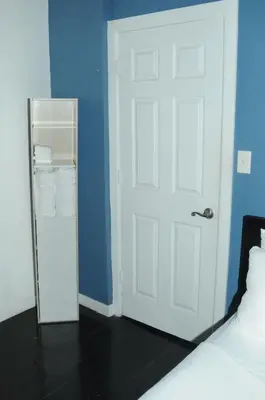 a bedroom with a white door and blue walls at Plush Spacious 1 bedroom apt Williamsburg in Brooklyn