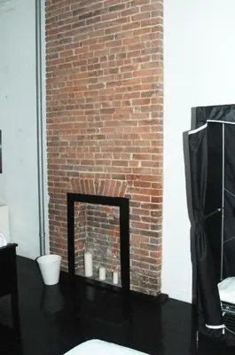 a brick fireplace in front of a brick wall at Plush Spacious 1 bedroom apt Williamsburg in Brooklyn