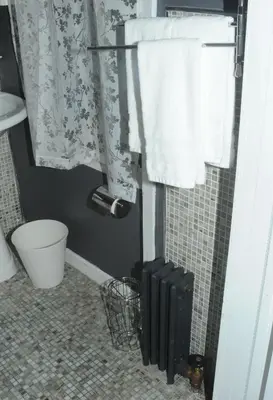 a bathroom with a shower with towels on the wall at Plush Spacious 1 bedroom apt Williamsburg in Brooklyn