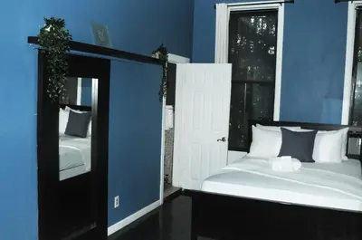 a blue room with a bed and a mirror at Plush Spacious 1 bedroom apt Williamsburg in Brooklyn