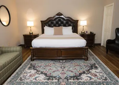 a bedroom with a large bed and a couch at D. Hotel Suites & Spa in Holyoke