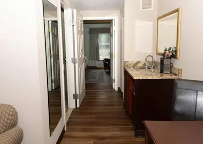 a kitchen with a sink and a hallway at D. Hotel Suites & Spa in Holyoke