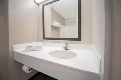 a white bathroom with a sink and a mirror at Extended Stay America Suites - Shelton - Fairfield County in Shelton