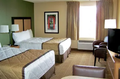 a hotel room with two beds and a television at Extended Stay America Suites - Shelton - Fairfield County in Shelton