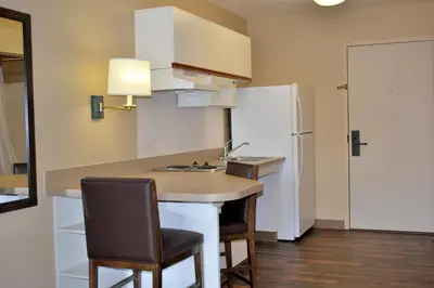a small kitchen with a counter and a refrigerator at Extended Stay America Suites - Shelton - Fairfield County in Shelton