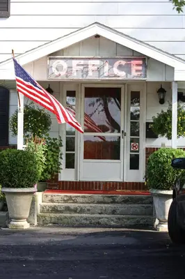 a store with an american flag in front of it at Chatham Travel Lodge in Old Chatham
