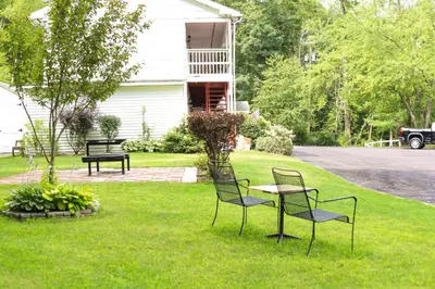 a group of chairs and a table in a yard at Chatham Travel Lodge in Old Chatham