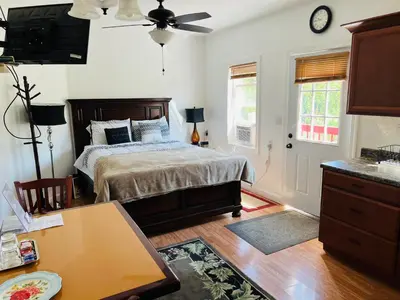 a bedroom with a bed and a table in it at Micosta Leisure Inn in Hudson