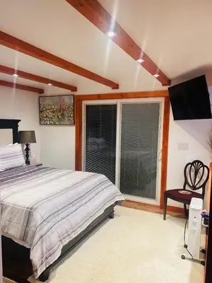 a bedroom with a bed and a large window at Micosta Leisure Inn in Hudson