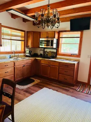 a kitchen with wooden cabinets and a chandelier at Micosta Leisure Inn in Hudson