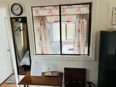 a window in a room with a table and a clock at Micosta Leisure Inn in Hudson