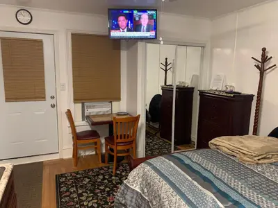 a bedroom with a bed and a tv on the wall at Micosta Leisure Inn in Hudson