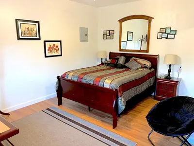 a bedroom with a bed and a mirror on the wall at Micosta Leisure Inn in Hudson