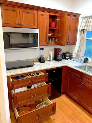 a kitchen with wooden cabinets and a counter top at Micosta Leisure Inn in Hudson