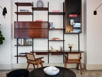a living room with two chairs and a table at Walker Hotel Tribeca in New York