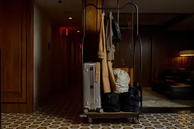 a room with a luggage rack with clothes at Walker Hotel Tribeca in New York