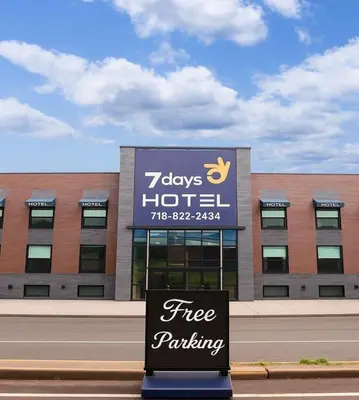 a free parking sign in front of a building at 7 Days Hotel in Bronx