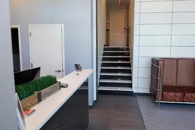 a hallway with a staircase and a stair case at 7 Days Hotel in Bronx