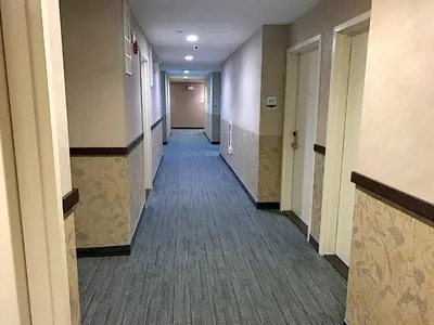 a hallway of a hospital with a long corridor at 7 Days Hotel in Bronx