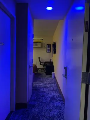 a hallway with blue lights in a room at 7 Days Hotel in Bronx