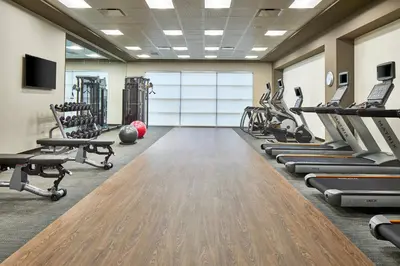 a gym with treadmills and cardio machines at Courtyard by Marriott Albany Airport in Albany