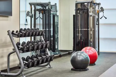 a gym with several rows of exercise equipment at Courtyard by Marriott Albany Airport in Albany