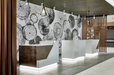 a room with a wall covered in black and white clocks at Courtyard by Marriott Albany Airport in Albany