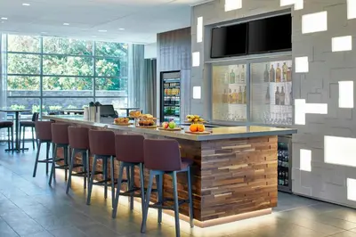 a kitchen with a large island with bar stools at Residence Inn by Marriott Albany Airport in Albany