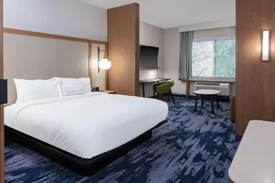 a hotel room with a bed and a desk at Fairfield Inn & Suites by Marriott Queensbury Glens Falls/Lake George in Queensbury