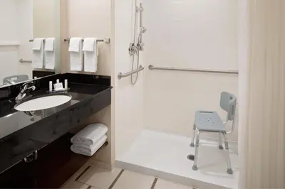 a bathroom with a sink and a chair in it at Fairfield Inn & Suites New York Manhattan/Downtown East in New York